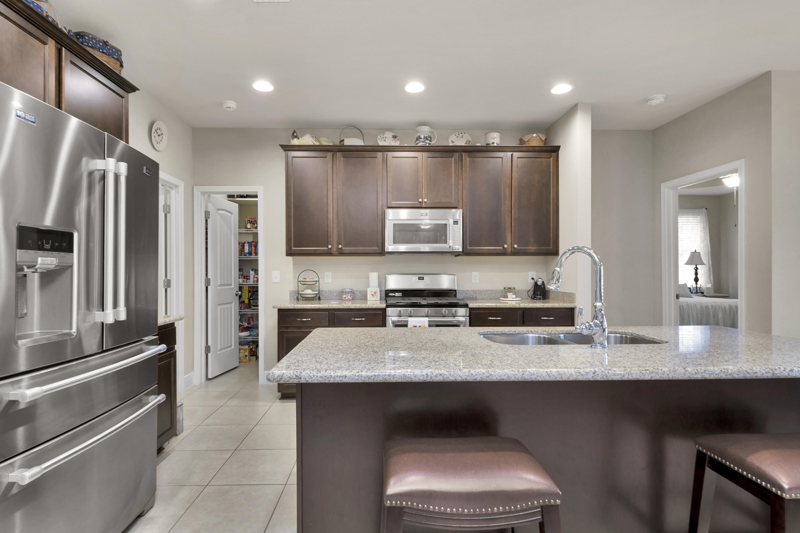 514 Brighton Cove Freeport, FL 32439 - Photo 12 of 32 a kitchen with stainless steel appliances granite countertop a refrigerator a sink and a stove