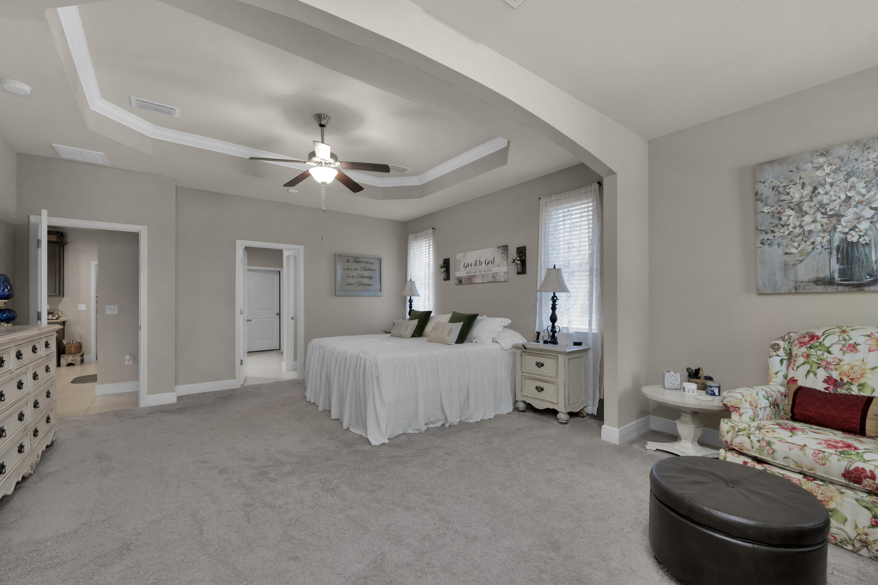 514 Brighton Cove Freeport, FL 32439 - Photo 17 of 32 a bed room with furniture and a chandelier