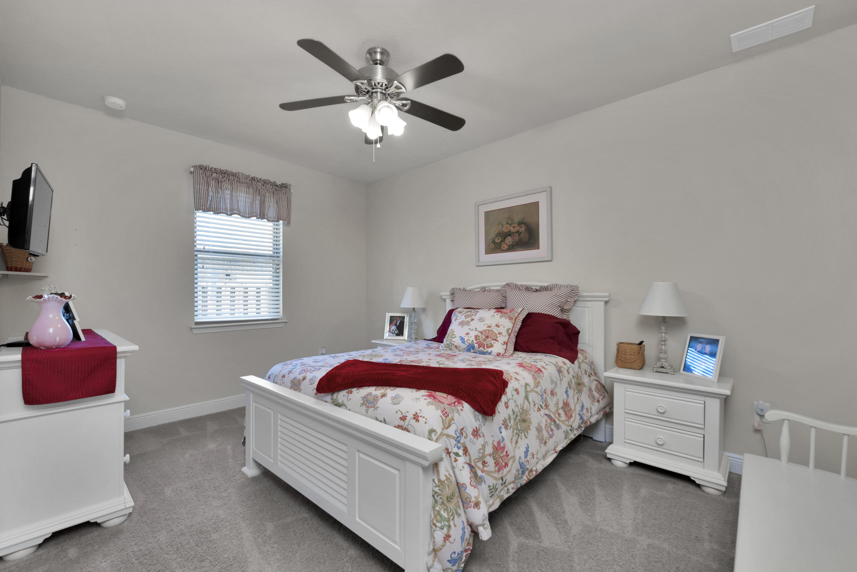 514 Brighton Cove Freeport, FL 32439 - Photo 22 of 32 a bedroom with a bed and a chandelier