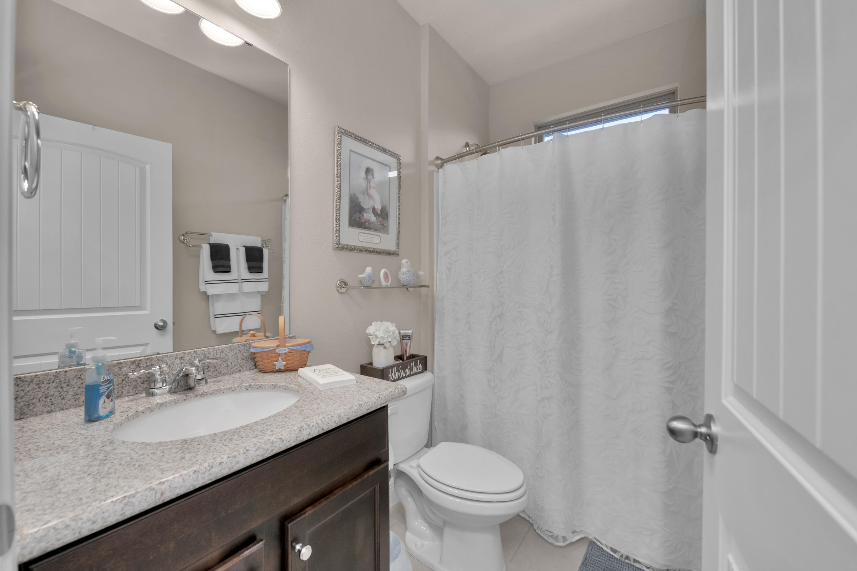 514 Brighton Cove Freeport, FL 32439 - Photo 23 of 32 a bathroom with a granite countertop sink and a mirror
