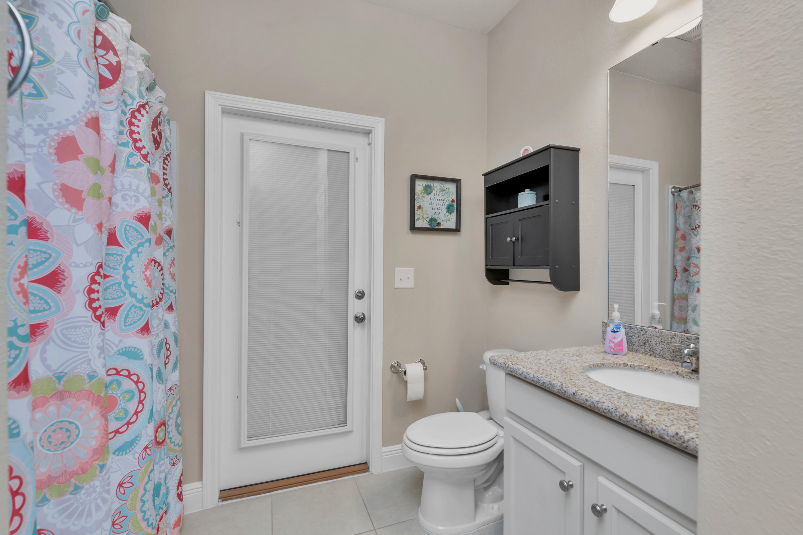 514 Brighton Cove Freeport, FL 32439 - Photo 25 of 32 a bathroom with a granite countertop sink and a mirror