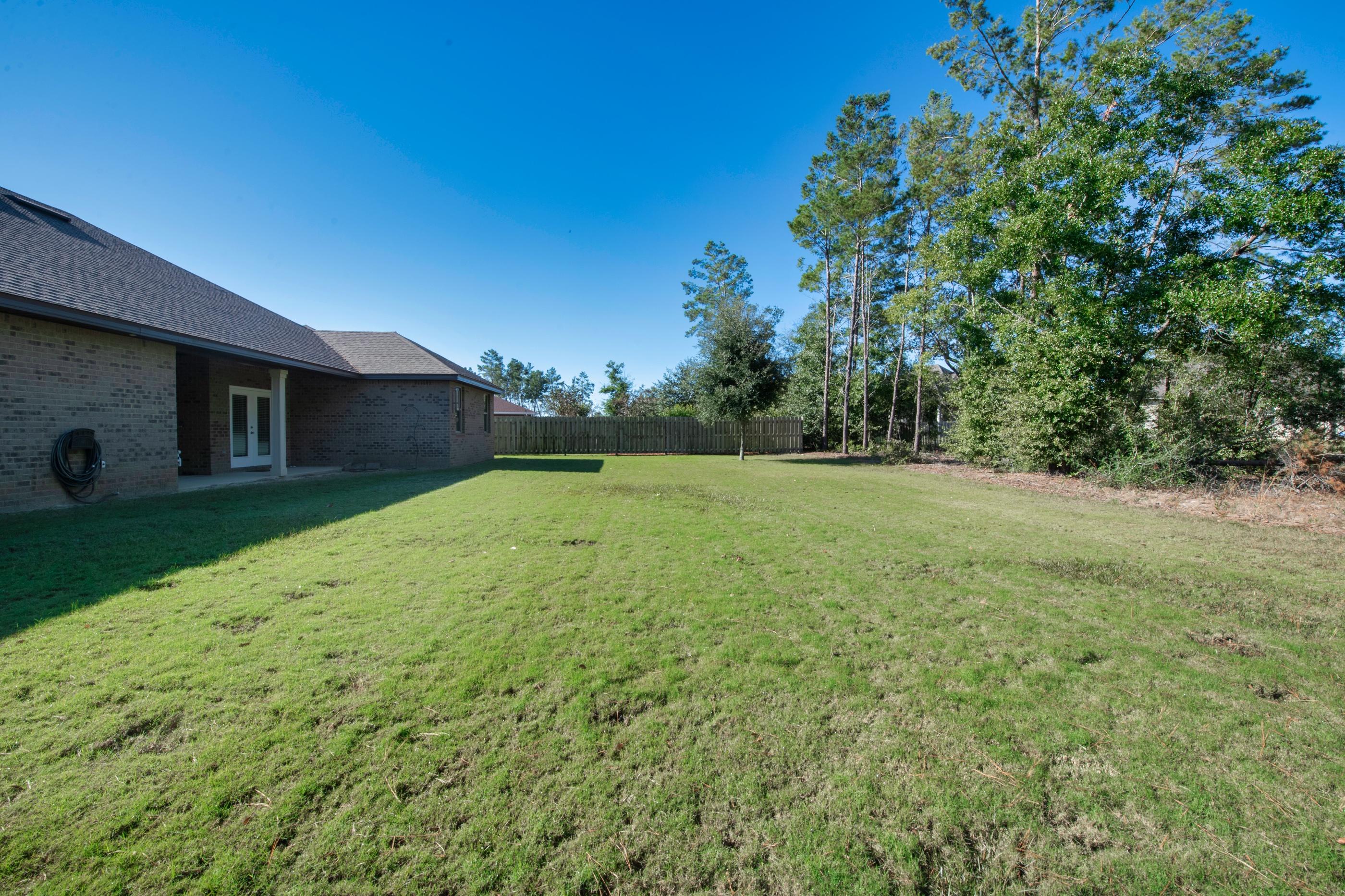 514 Brighton Cove Freeport, FL 32439 - Photo 30 of 32 a view of a backyard with a garden