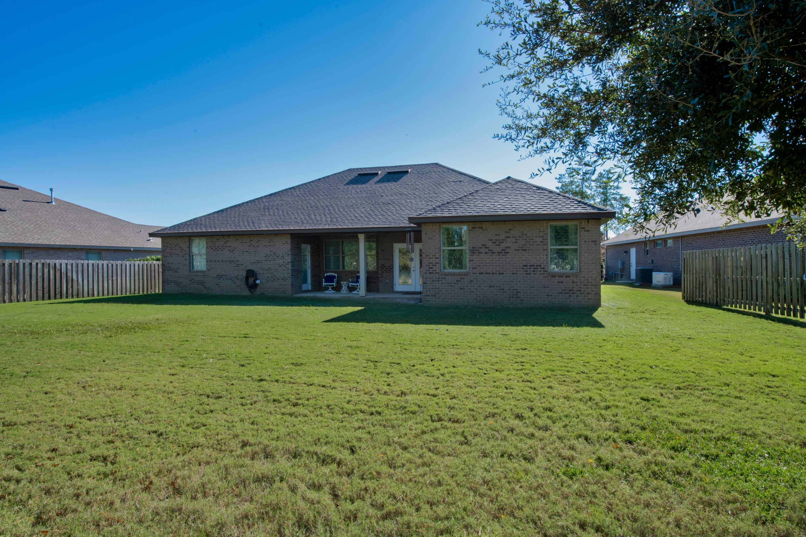 514 Brighton Cove Freeport, FL 32439 - Photo 32 of 32 a front view of a house with a garden
