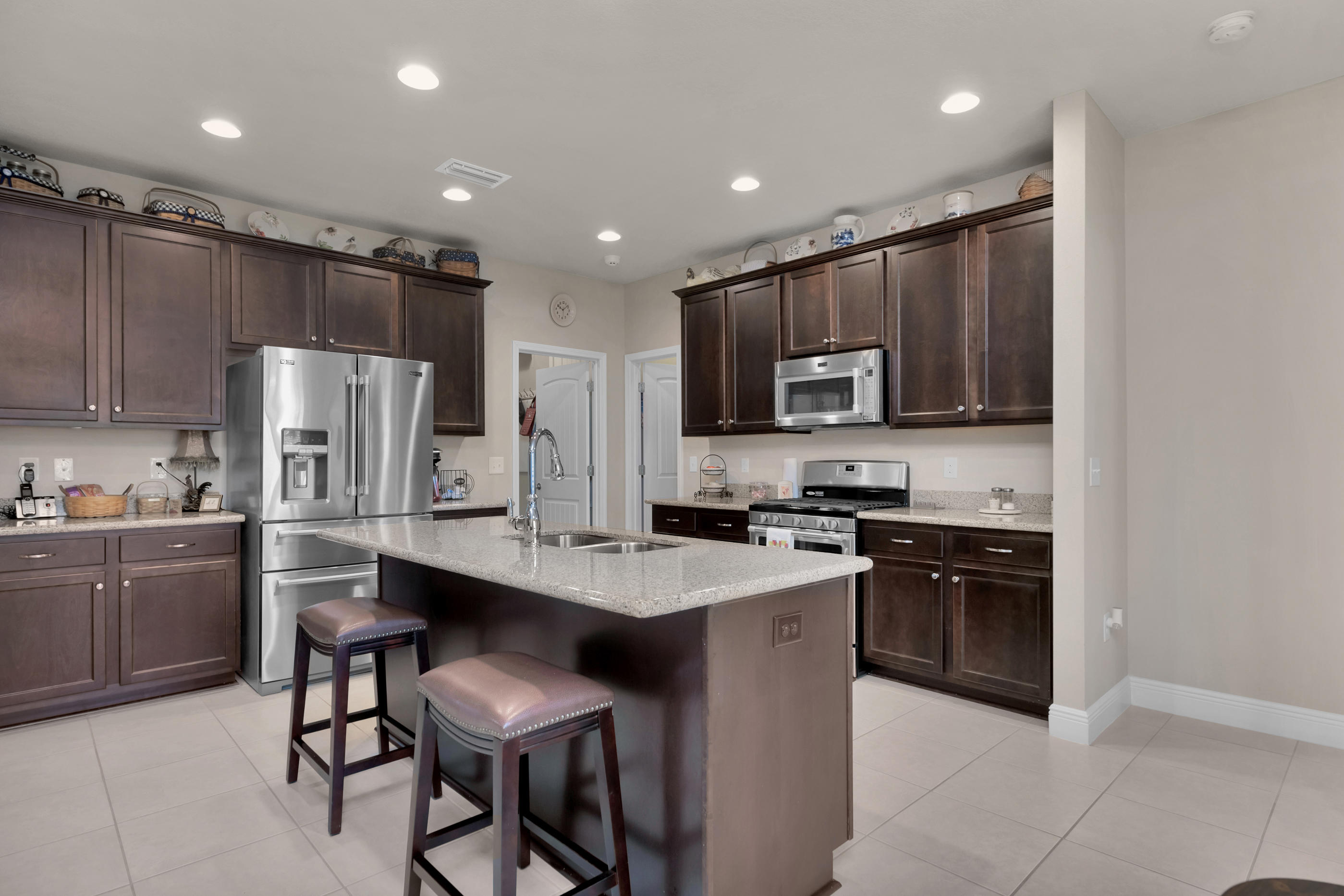 514 Brighton Cove Freeport, FL 32439 - Photo 6 of 32 a kitchen with stainless steel appliances granite countertop a refrigerator stove microwave and sink