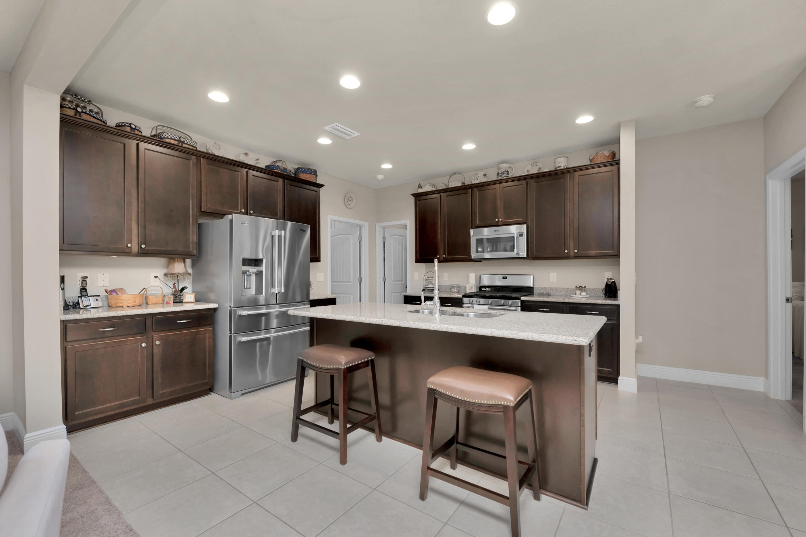 514 Brighton Cove Freeport, FL 32439 - Photo 7 of 32 a kitchen with refrigerator a sink and chairs