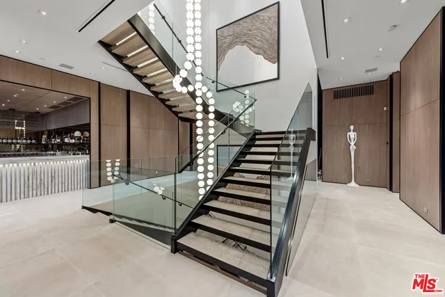 a dining room with furniture a flat screen tv and a large window