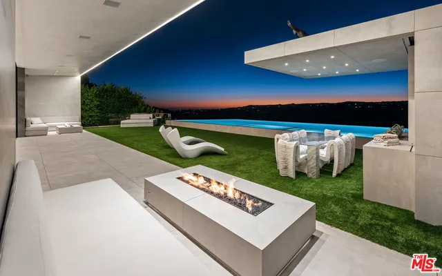 a view of kitchen with stainless steel appliances granite countertop a sink stove and refrigerator