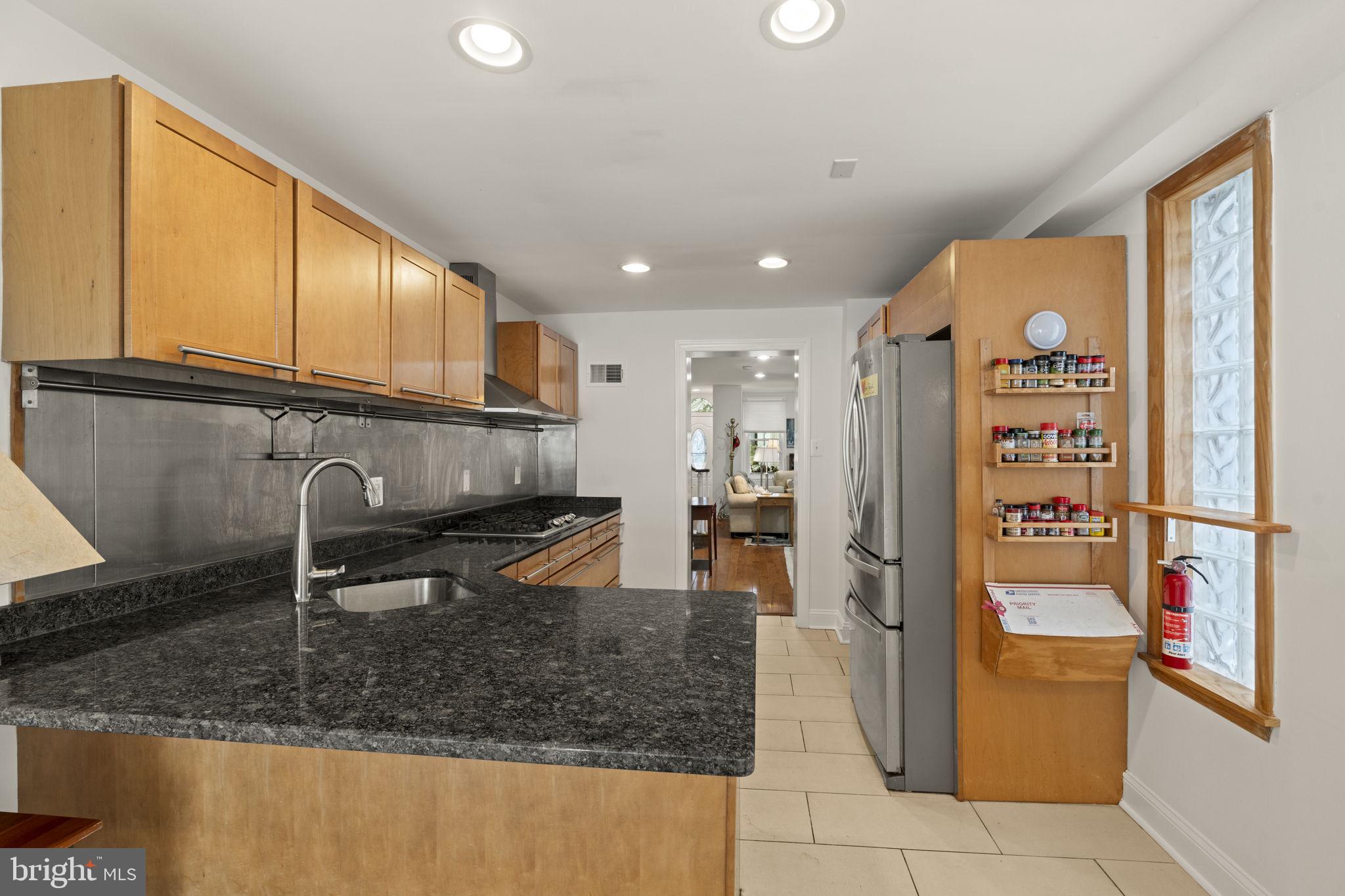 1913 Carpenter Street Philadelphia, PA 19146 - Photo 11 of 39 a kitchen with stainless steel appliances granite countertop a refrigerator and a sink