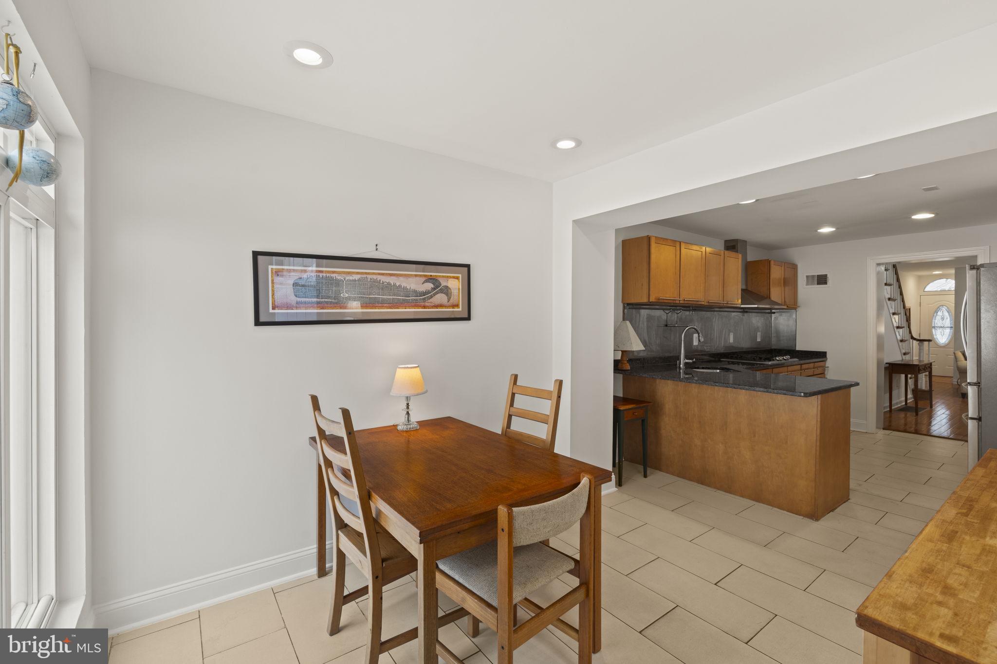 1913 Carpenter Street Philadelphia, PA 19146 - Photo 12 of 39 a kitchen with a dining table chairs and large window
