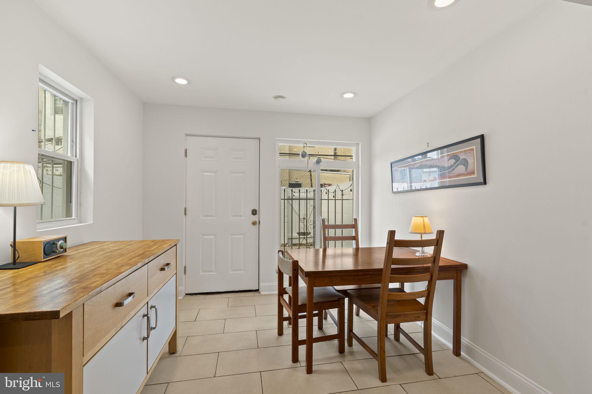 1913 Carpenter Street Philadelphia, PA 19146 - Photo 13 of 39 a room with a table chairs and a refrigerator