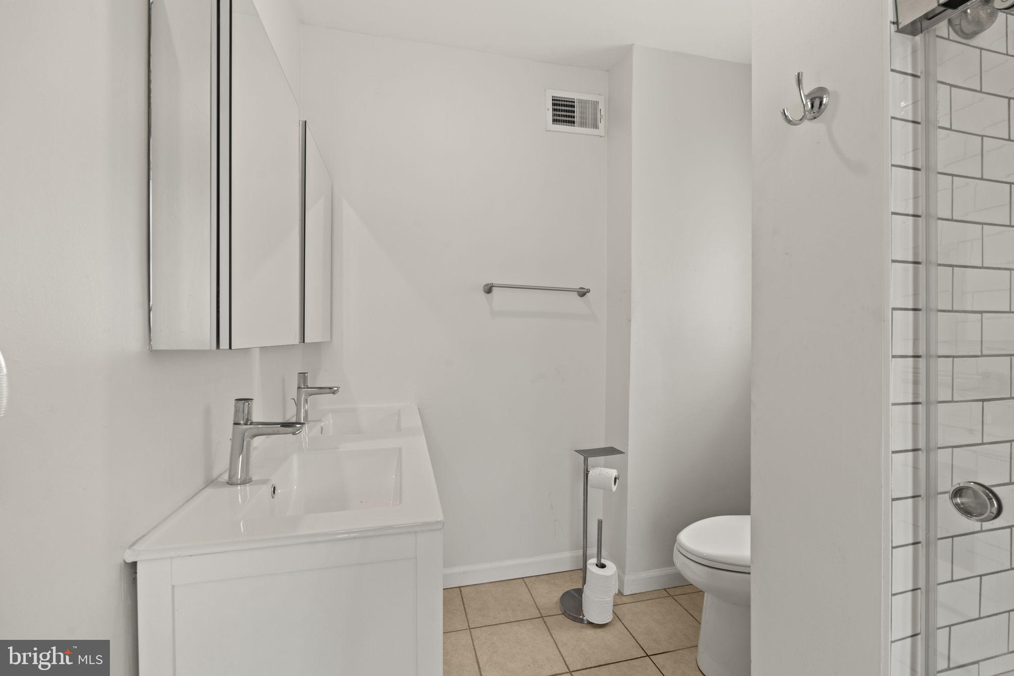 1913 Carpenter Street Philadelphia, PA 19146 - Photo 15 of 39 a bathroom with a sink a toilet and shower