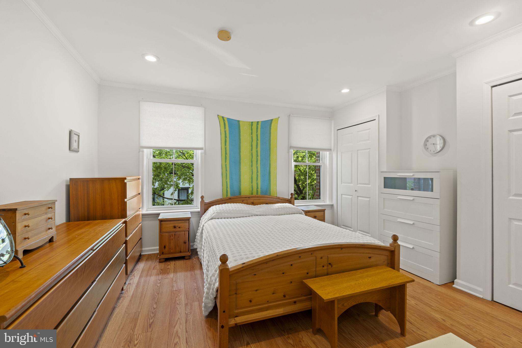 1913 Carpenter Street Philadelphia, PA 19146 - Photo 19 of 39 a bedroom with a bed and wooden floor