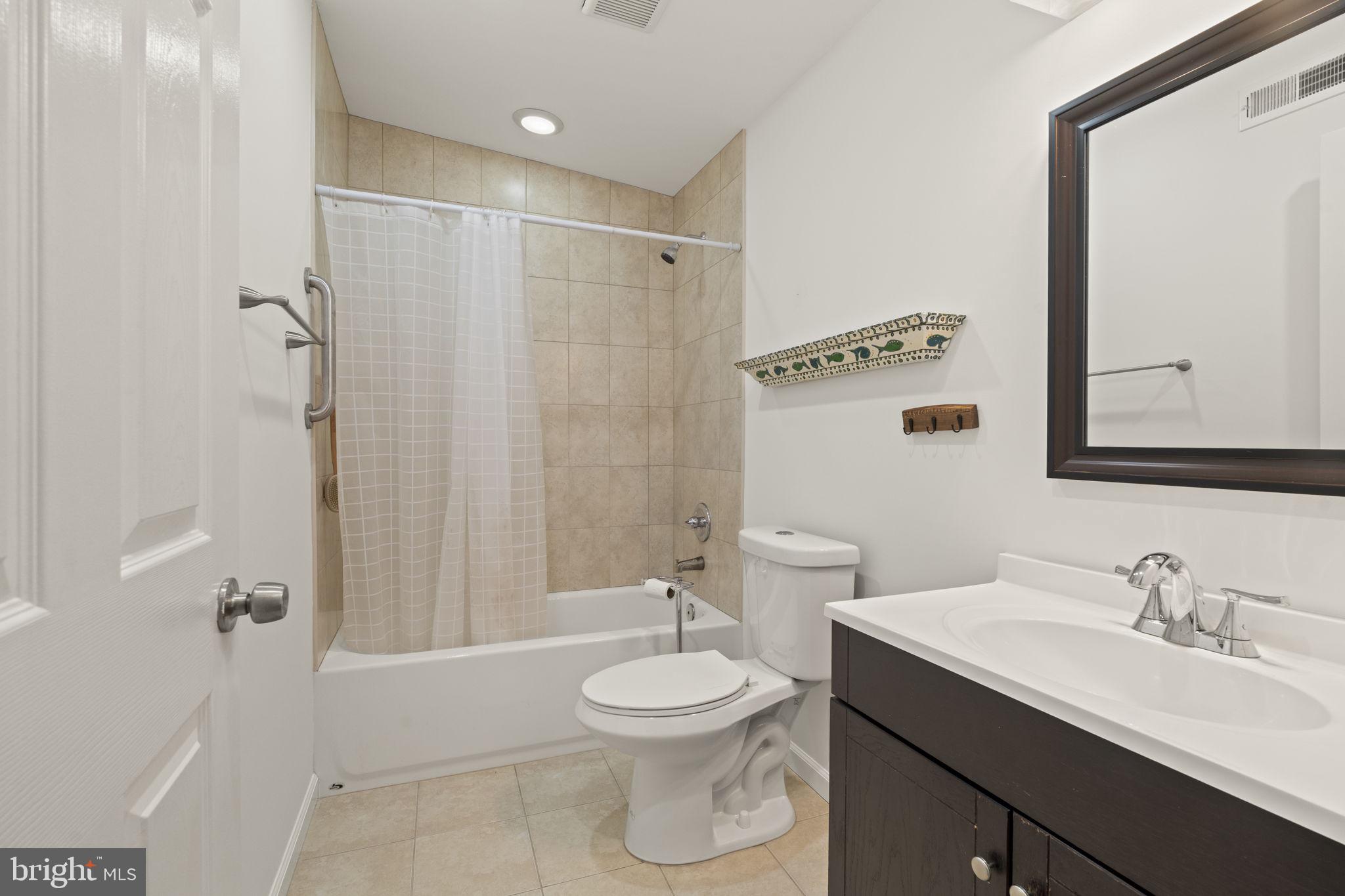 1913 Carpenter Street Philadelphia, PA 19146 - Photo 26 of 39 a bathroom with a toilet a sink a mirror and a shower