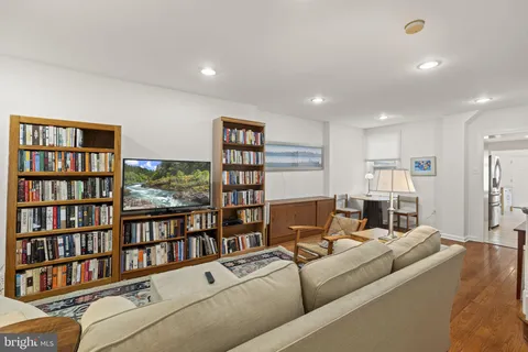 a living room with furniture and a book shelf