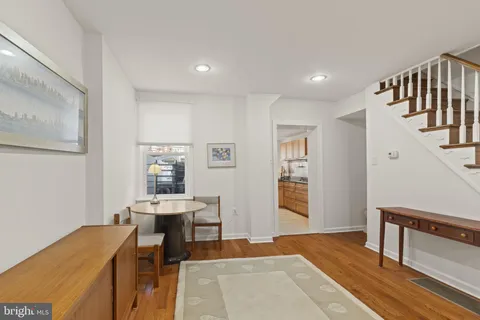 a living room with lots of furniture and a wooden floor