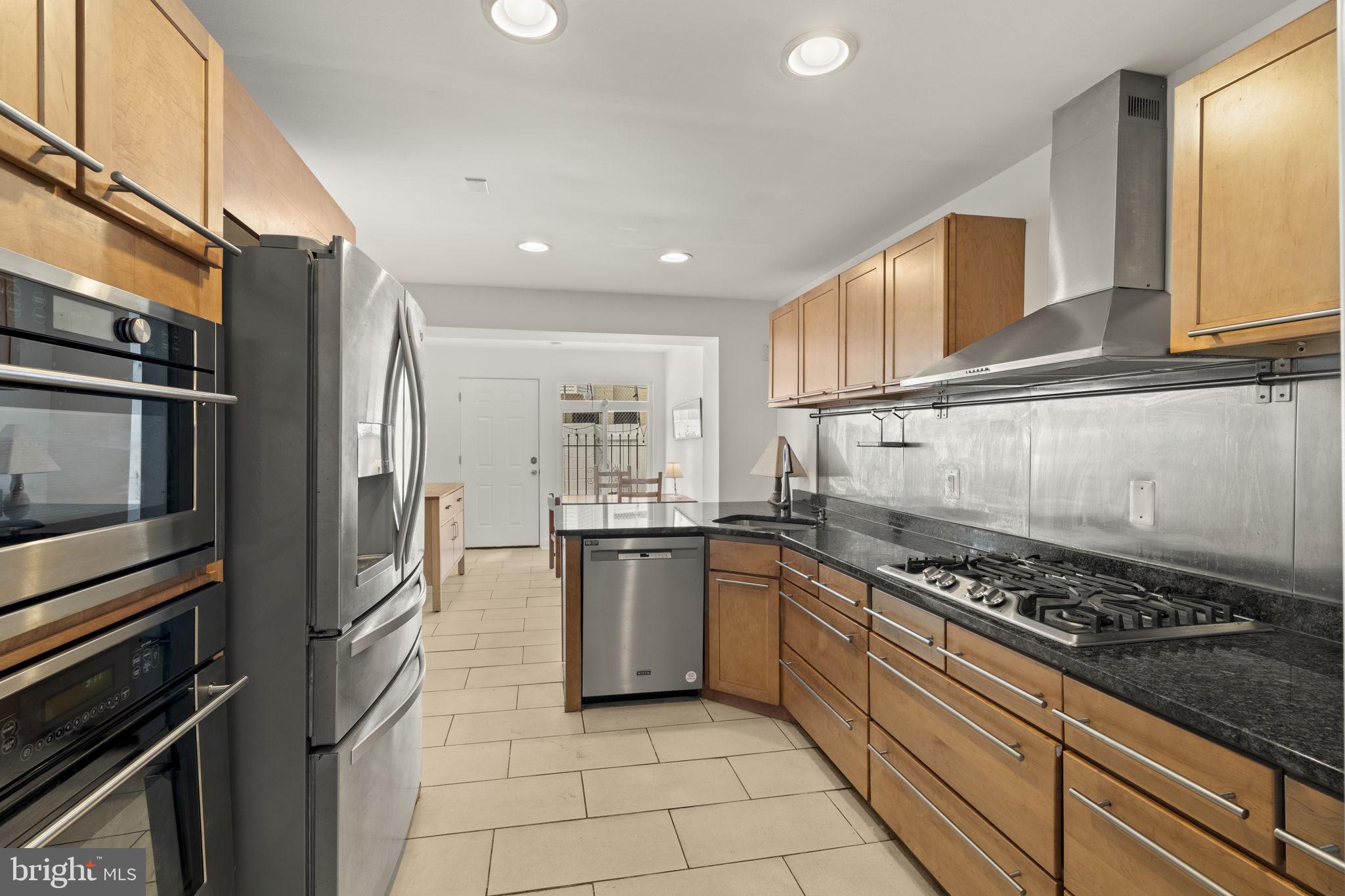1913 Carpenter Street Philadelphia, PA 19146 - Photo 9 of 39 a kitchen with stainless steel appliances granite countertop a stove and a refrigerator