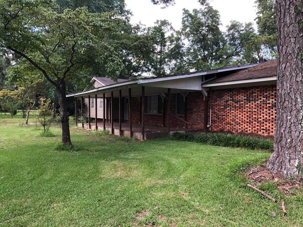 1348 Main Street Perry, GA 31069 - Photo 2 of 20 a view of backyard with large trees and wooden fence