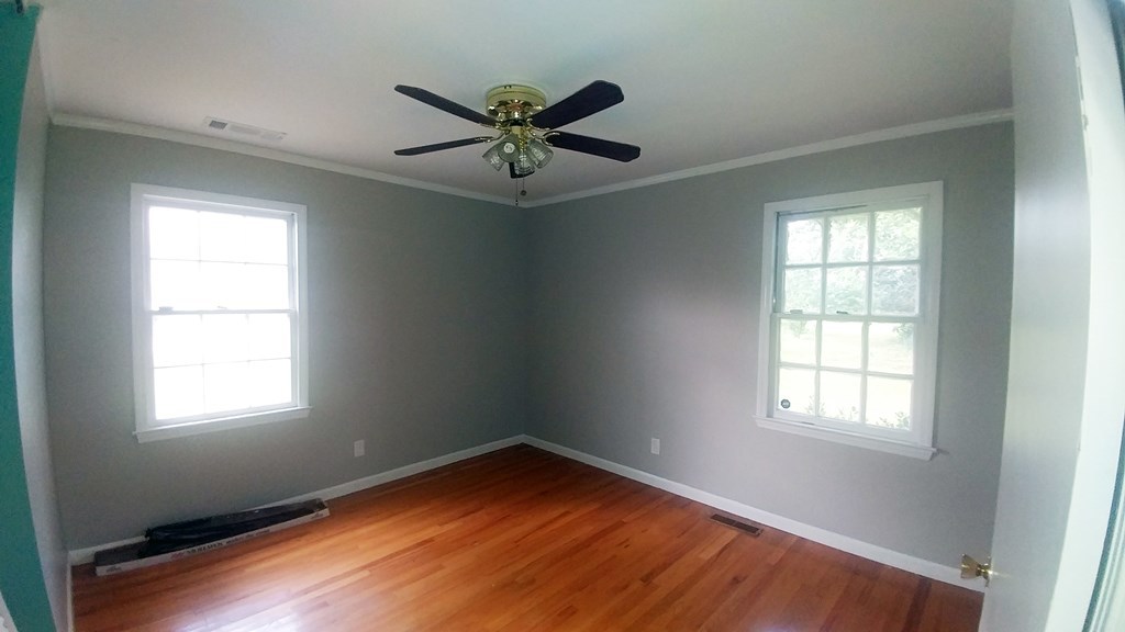 1348 Main Street Perry, GA 31069 - Photo 14 of 20 a view of empty room with wooden floor and fan