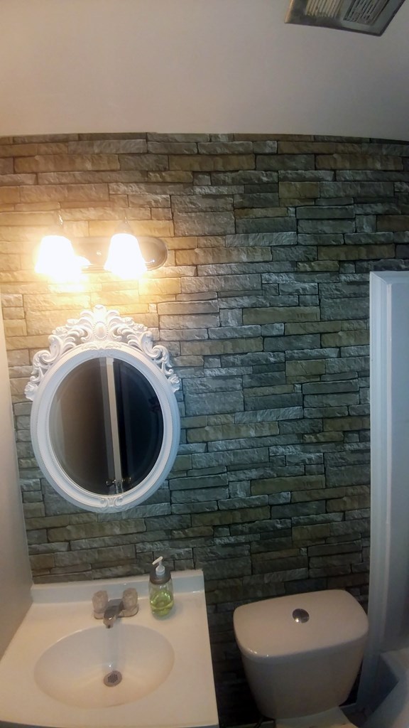 1348 Main Street Perry, GA 31069 - Photo 15 of 20 a bathroom with a sink a toilet and a mirror