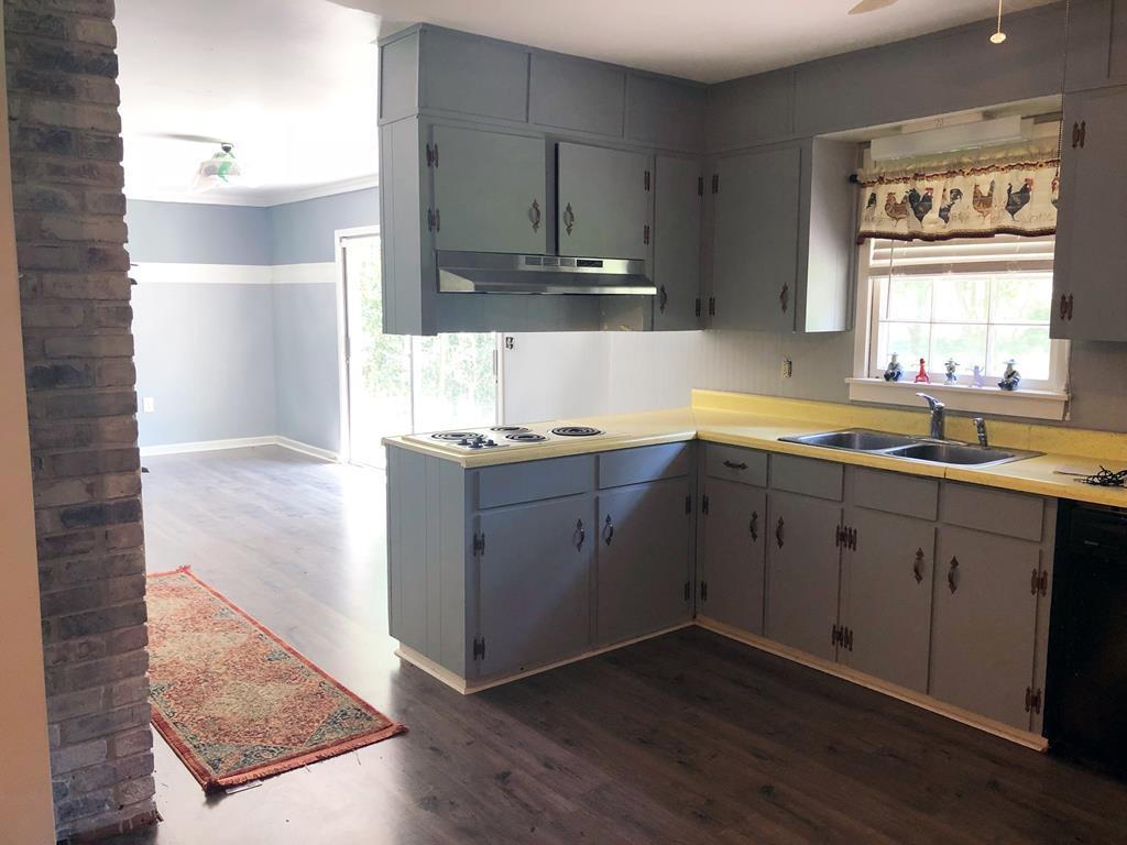 1348 Main Street Perry, GA 31069 - Photo 8 of 20 a kitchen with a sink window and cabinets