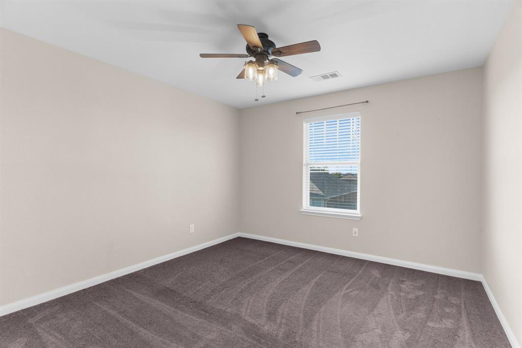 144 Perkins Street Anna, TX 75409 - Photo 16 of 31 an empty room with a window and a ceiling fan