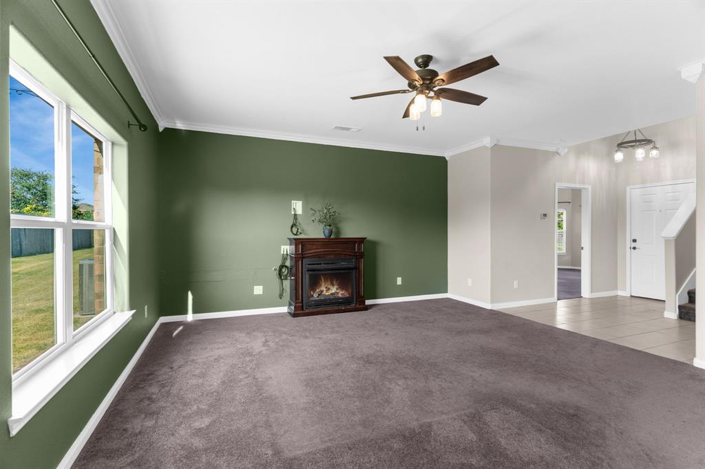 144 Perkins Street Anna, TX 75409 - Photo 5 of 31 a view of an empty room with a ceiling fan and a window
