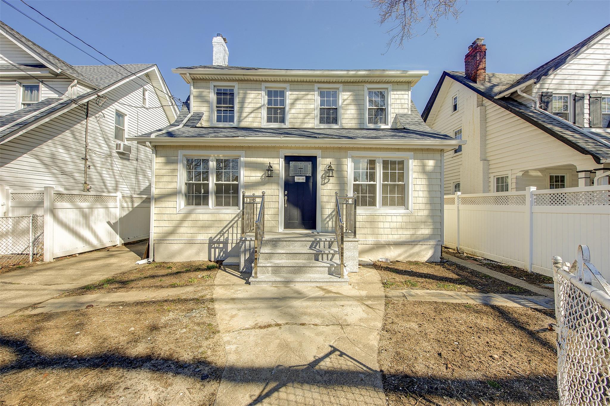 View of front of property with roof with shingles and fence