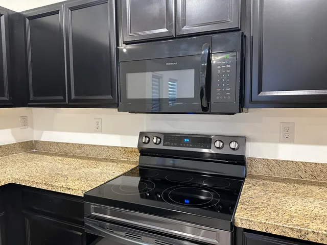 a stove top oven sitting inside of a kitchen