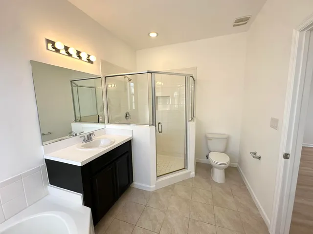 a bathroom with a sink toilet vanity and mirror