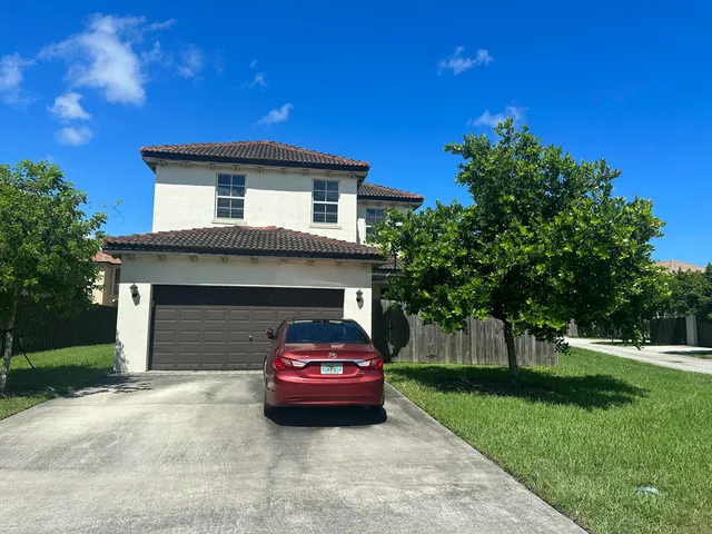 a red house with trees in front of it