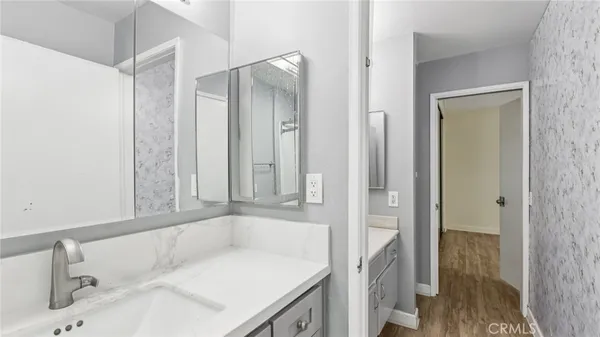 a bathroom with a tub sink and mirror