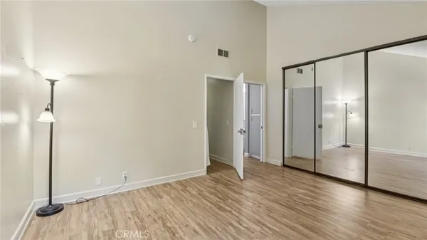 a view of empty room with wooden floor