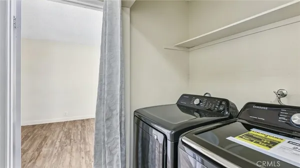 a view of bedroom with washer and dryer