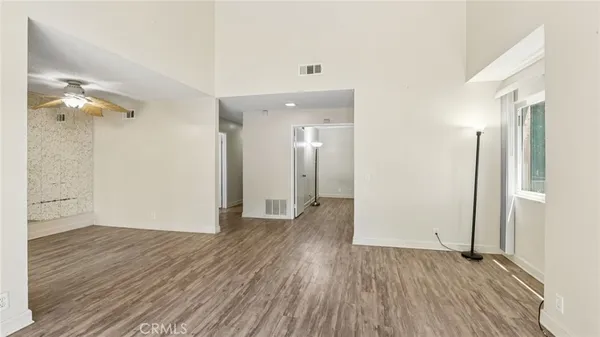 a view of a room with wooden floor and a bathroom