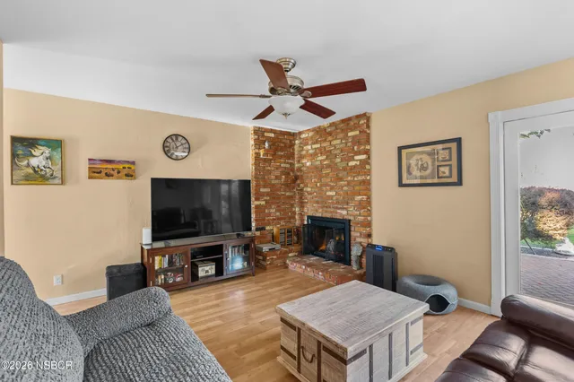 a living room with furniture a flat screen tv and a fireplace