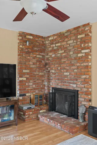 a view of living room with furniture and a fireplace