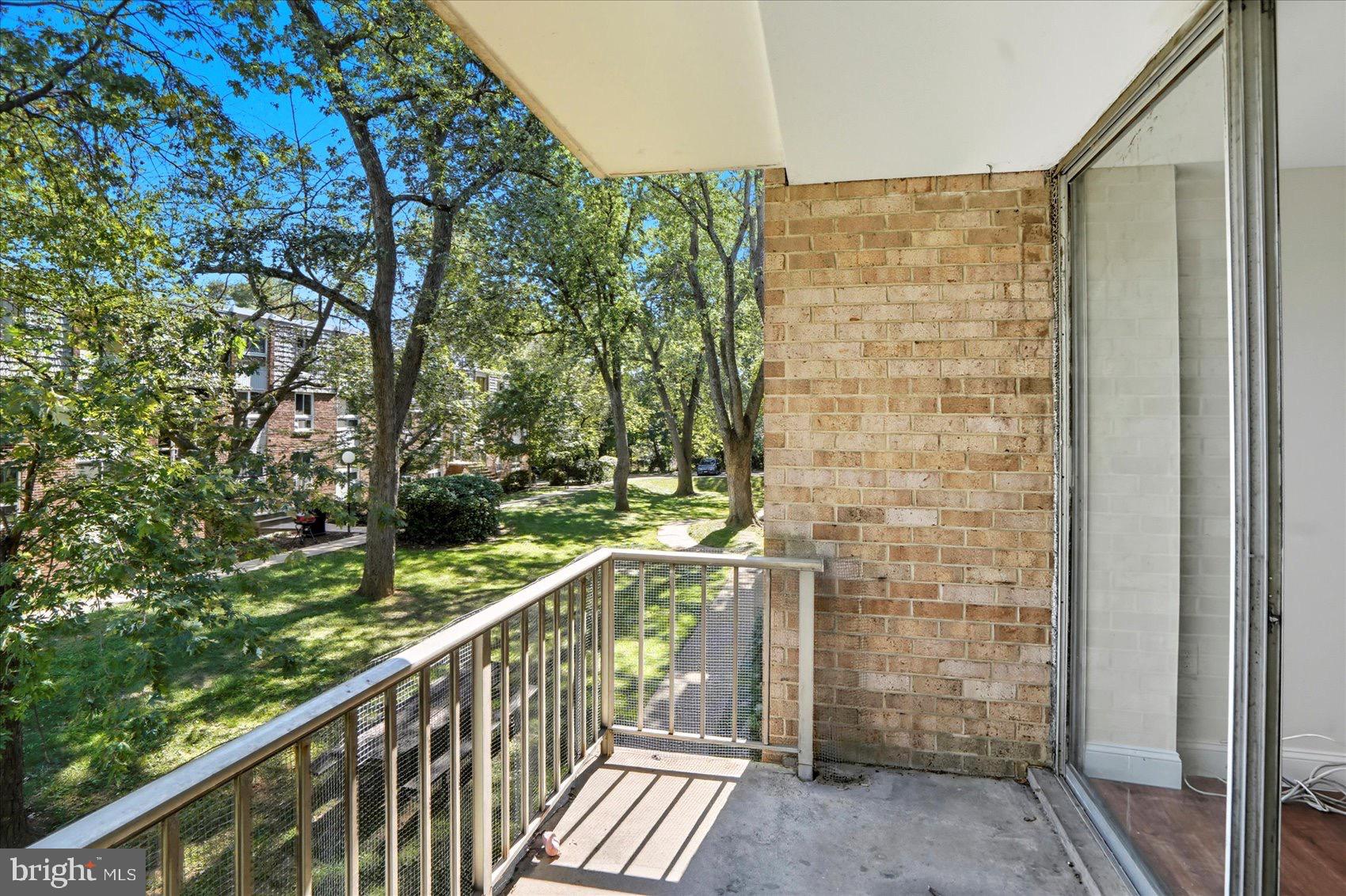 3960 Bel Pre Road, Unit 4 Silver Spring, MD 20906 - Photo 12 of 35 Serene balcony overlooking lush greenery.