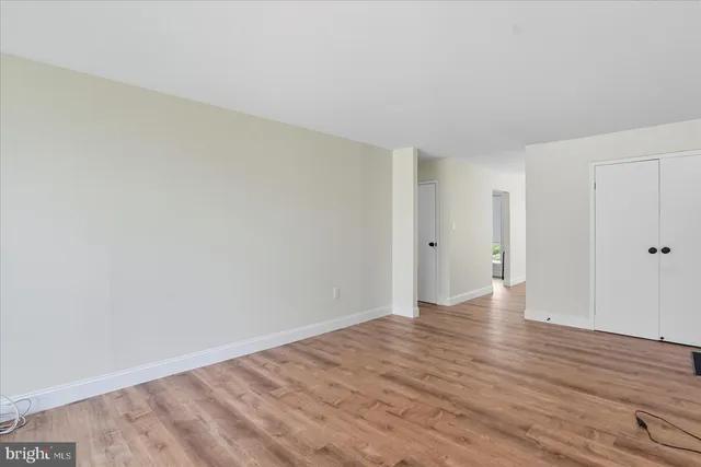 a view of an empty room and wooden floor