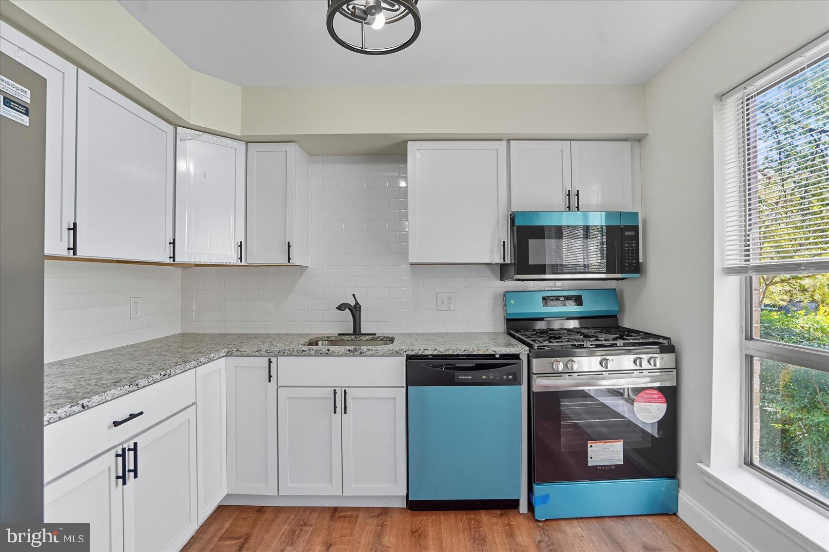 3960 Bel Pre Road, Unit 4 Silver Spring, MD 20906 - Photo 20 of 35 Modern kitchen with vibrant accents.