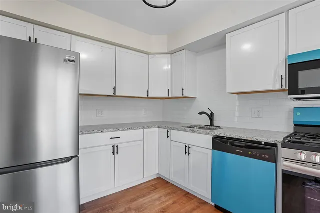 a kitchen with cabinets appliances and a counter space