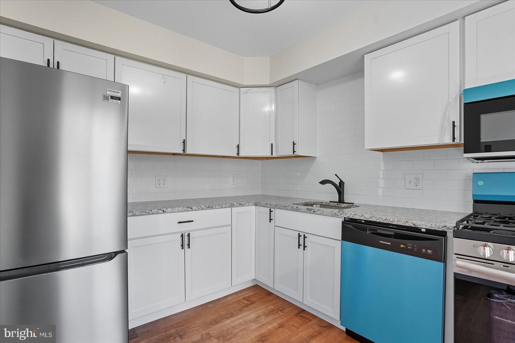 3960 Bel Pre Road, Unit 4 Silver Spring, MD 20906 - Photo 21 of 35 Modern kitchen with sleek finishes.