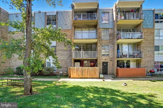 a front view of a building with a garden