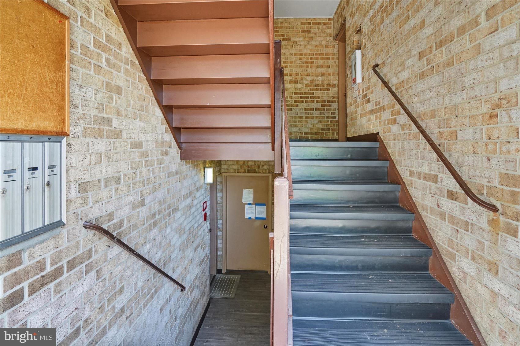 3960 Bel Pre Road, Unit 4 Silver Spring, MD 20906 - Photo 8 of 35 Inviting staircase with warm brick accents.