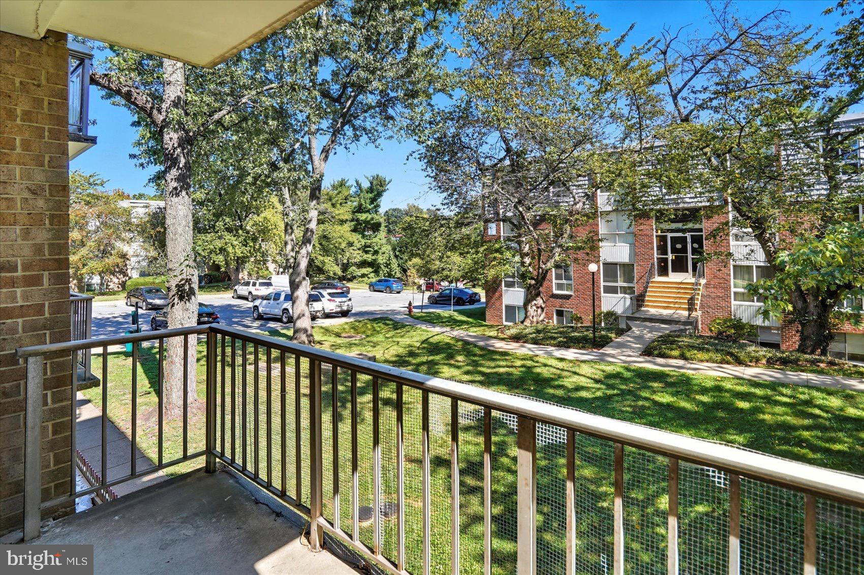 3960 Bel Pre Road, Unit 4 Silver Spring, MD 20906 - Photo 10 of 35 Sunny balcony view of lush greenery.