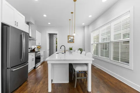 a kitchen with a sink stove and refrigerator