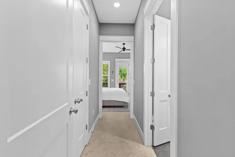 a spacious bedroom with a bed and a flat screen tv