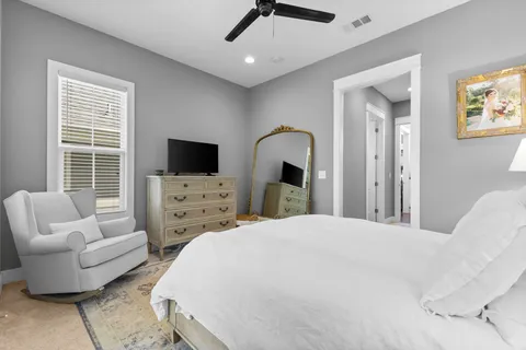 a bedroom with bed and large window