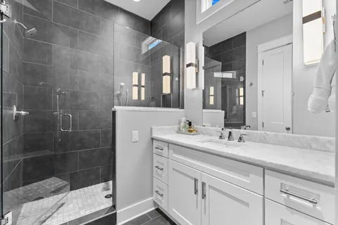 a bathroom with a granite countertop sink vanity and a mirror