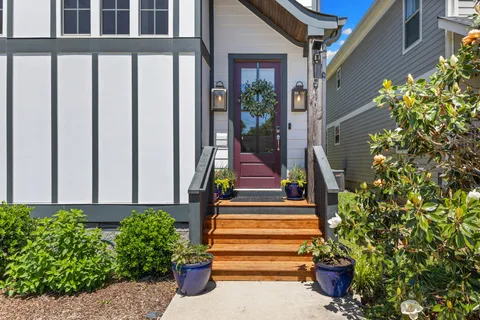 a front view of a house with plants