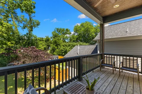 a view of a balcony with wooden floor